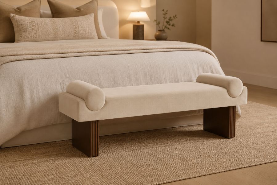 beige velvet bolster with fluted wood legs